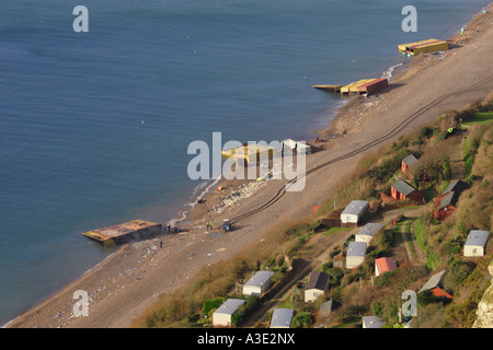 Pollution on Branscombe Beach DevonUK  among beach huts of wrecked shipping containers from the MSC Napoli ship January 2007 UK Stock Photo