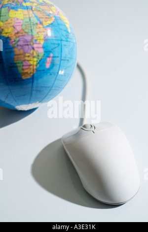 Computer Mouse Linked to a Globe of the World Stock Photo