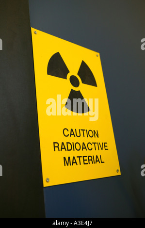 Warning sign 'Caution radioactive material' attached to door Stock Photo