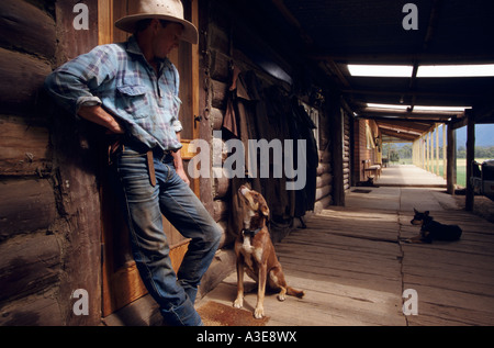 Stockman outside original log cabin where he lived as a child, NE  Victoria, Australia Stock Photo