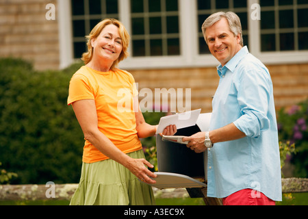 Portrait of a mature couple standing near a mailbox Stock Photo