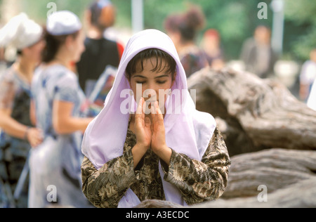 A woman at a ceremonial tree in Bukhara, Uzbekistan Stock Photo