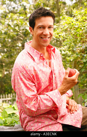 Portrait of a mature man holding an apple Stock Photo