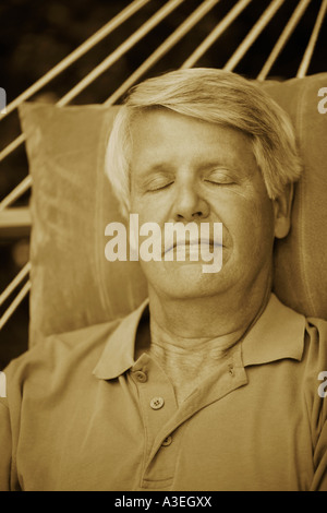 Close-up of a mature man sleeping in a hammock Stock Photo