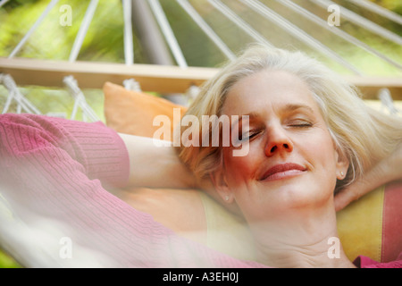 Close-up of a mature woman sleeping in a hammock Stock Photo