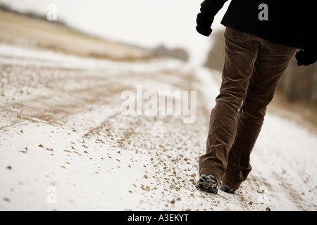 Person walking along road Stock Photo