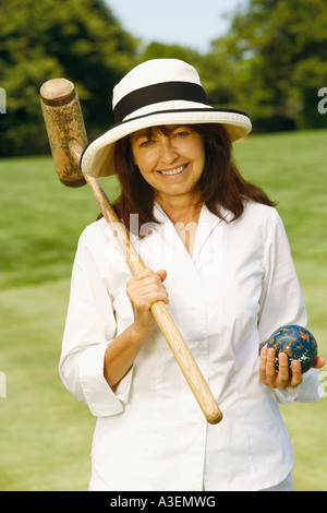 Portrait of a mature woman holding a croquet mallet and a ball Stock Photo