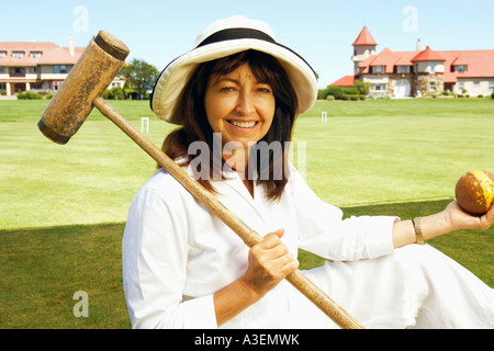 Portrait of a mature woman holding a croquet mallet and a ball Stock Photo