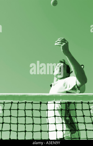 Low angle view of a mid adult man playing tennis Stock Photo