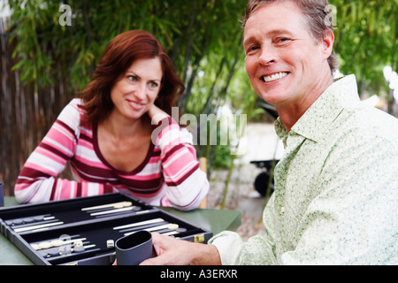 Mature man and mature woman playing backgammon Stock Photo