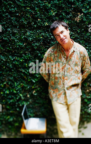 Portrait of a mature man leaning against a wall Stock Photo