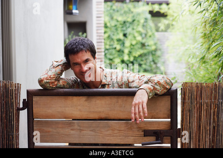 Portrait of a mature man leaning on a gate Stock Photo