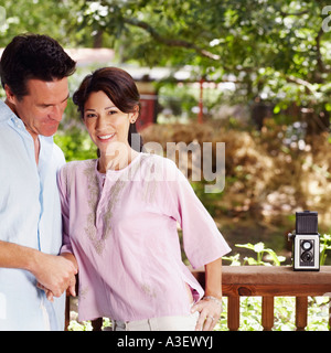 Mature couple leaning against a railing Stock Photo