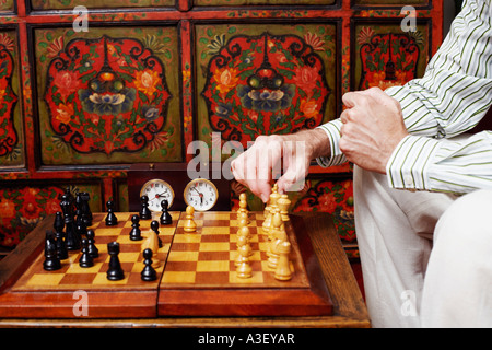 Mid section view of a man playing chess Stock Photo