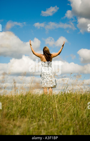 Woman with hands raised Stock Photo
