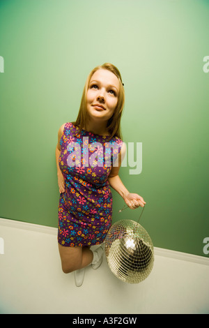 Woman holding a disco ball Stock Photo