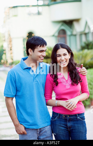 Young couple standing together and smiling Stock Photo