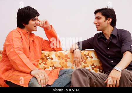 Two young men talking to each other Stock Photo