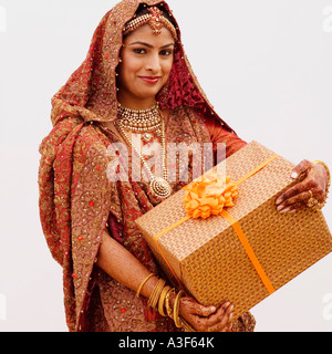 Portrait of a bride holding a gift Stock Photo