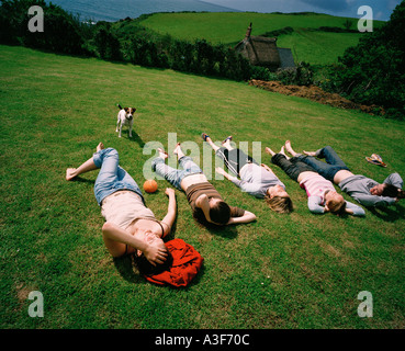 teenage girls sunbathing on green lawn Stock Photo