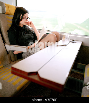 woman reading on train Stock Photo
