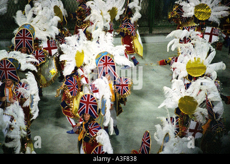 Men and women in costume dancing parading in the road in Rio Carnival Stock Photo