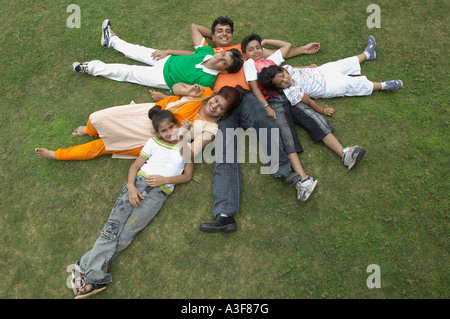 High angle view of a family lying on ground and smiling Stock Photo