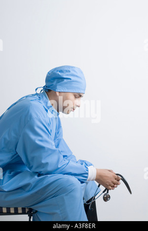 surgeon is sitting on a chair in the operating room Stock Photo - Alamy