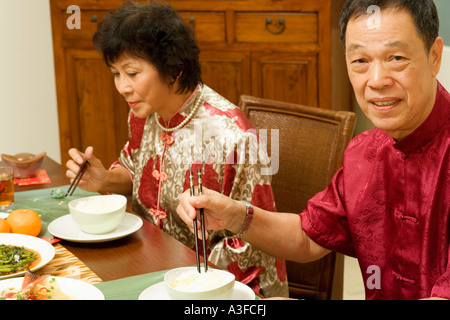 Portrait of a senior man sitting at a dining table with a mature woman beside him Stock Photo