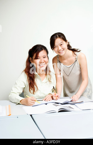 Portrait of a professor and a young woman smiling in the classroom Stock Photo