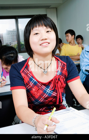 Close-up of students sitting in a classroom and smiling Stock Photo