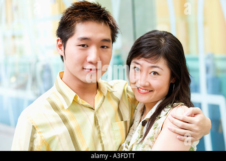 Portrait of a young man embracing a young woman Stock Photo
