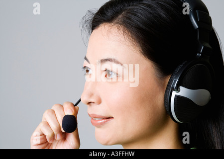 Side profile of a businesswoman using a headset Stock Photo