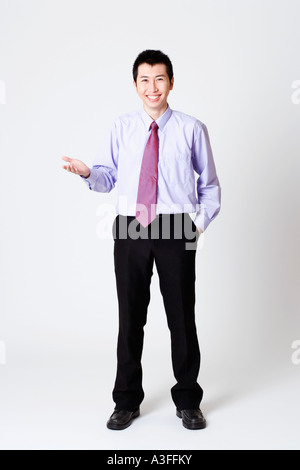 Portrait of a businessman gesturing and smiling Stock Photo