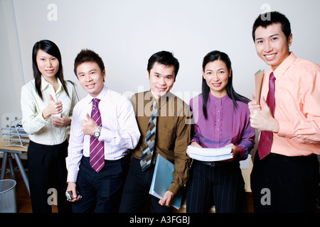Portrait of five business executives standing and smiling together Stock Photo