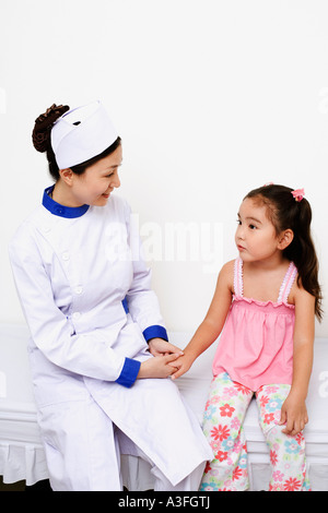 Female nurse holding a girl's hand Stock Photo