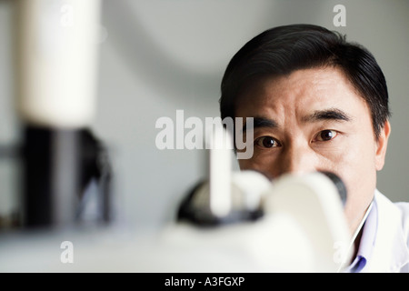 Close-up of an optometrist in front of an ophthalmoscope Stock Photo