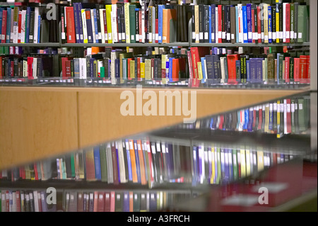 Library Books on shelves and reflecting in a glass display case architectural architecture building edifice edifices library Stock Photo