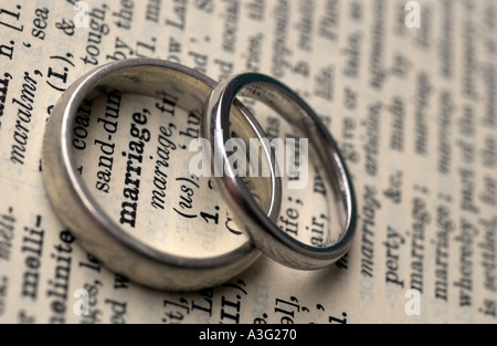 Wedding rings on a dictionary showing the word marriage Stock Photo