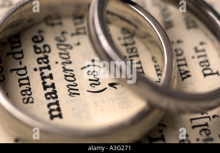 Wedding rings on a dictionary showing the word marriage Stock Photo