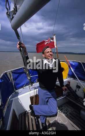 sailor at the helm of sailing boat in the Humber estuary Hull UK Stock Photo