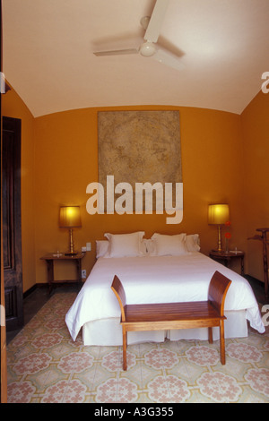 Hotel Room with Yellow Bedspread and Bed Reflected in a Mirror Stock ...