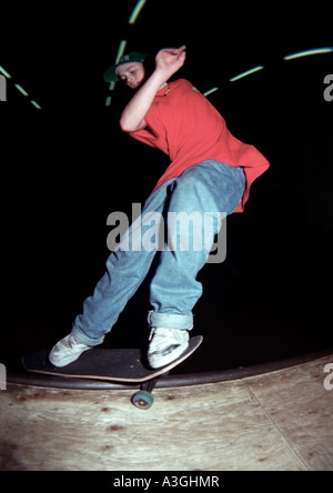 Colin Mckay skateboarder doing front side smith grind on an mini ramp Stock Photo