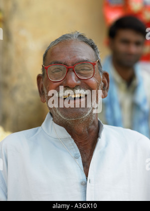Elderly Indian man with his son outside his shop in Udaipur in Rajasthan, India Stock Photo