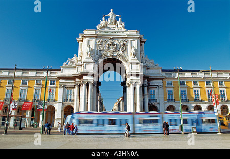 Portugal, Lisbon: Tram passing in front of the Triumph Arch at Praca do Comercio Square Stock Photo