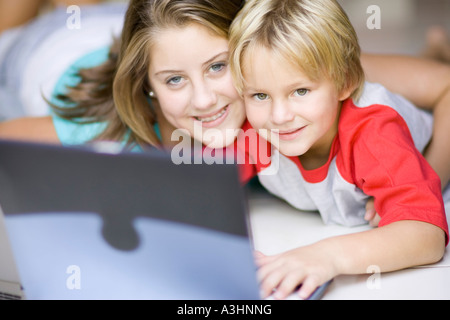Girl and Boy Using Laptop Computer Stock Photo