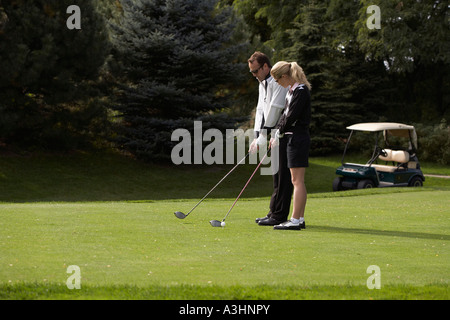 Man and Woman Golfing Stock Photo