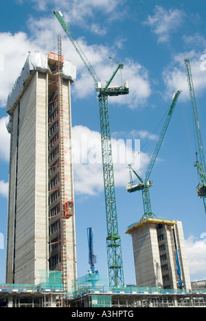 Structural concrete core new high rise office blocks by construction business on building industry site passenger hoist & crane jibs London England UK Stock Photo