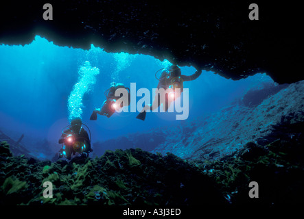 skin divers exploring underwater cave in Florida spring Stock Photo