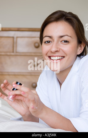 Woman holding a bottle of nail polish Stock Photo